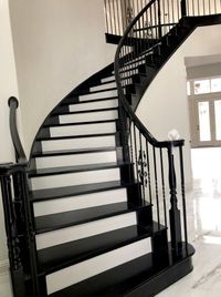Curved staircase with black-stained treads and crisp white risers