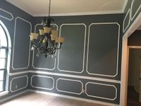 Dining room painted charcoal with white picture-frame molding