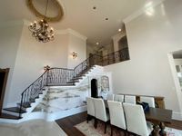 Formal dining room and staircase with freshly painted walls and white trim