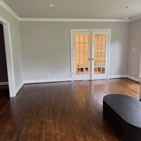 Living room with light gray walls and white French doors