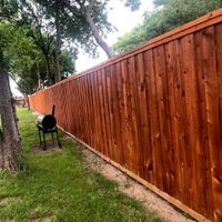 Long cedar privacy fence with a fresh, rich stain