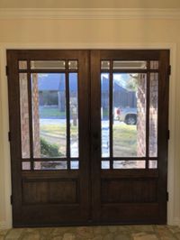 Stained wood double entry doors with glass panes