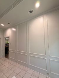 Wall with white board-and-panel molding